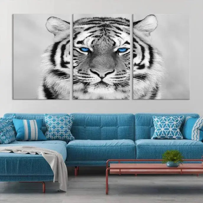 A piece from the Black and White Tiger Wall Art Animal Canvas Print collection, showcasing a white tiger with blue eyes on premium canvas, is displayed.