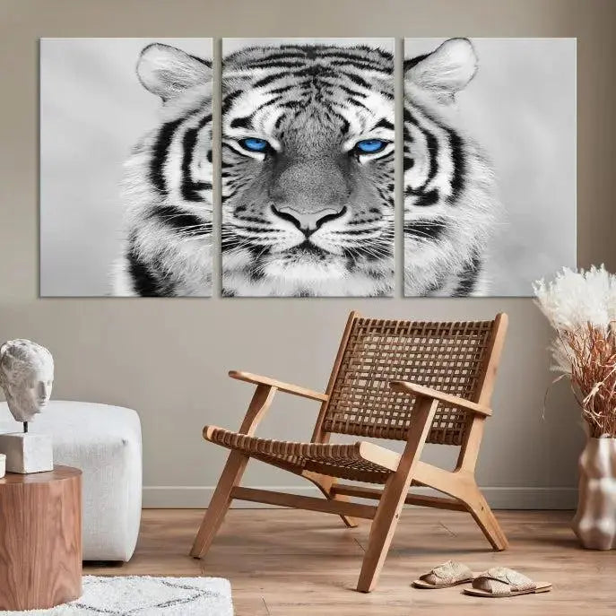 A piece from the Black and White Tiger Wall Art Animal Canvas Print collection, showcasing a white tiger with blue eyes on premium canvas, is displayed.