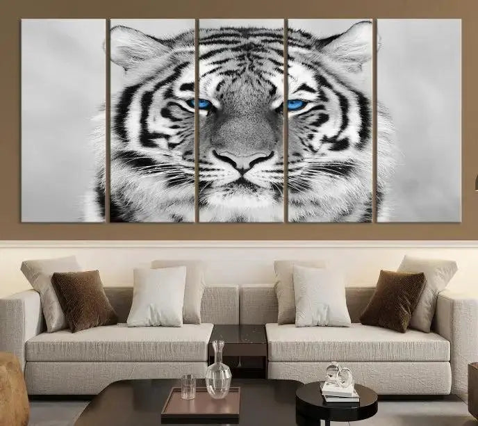 A piece from the Black and White Tiger Wall Art Animal Canvas Print collection, showcasing a white tiger with blue eyes on premium canvas, is displayed.