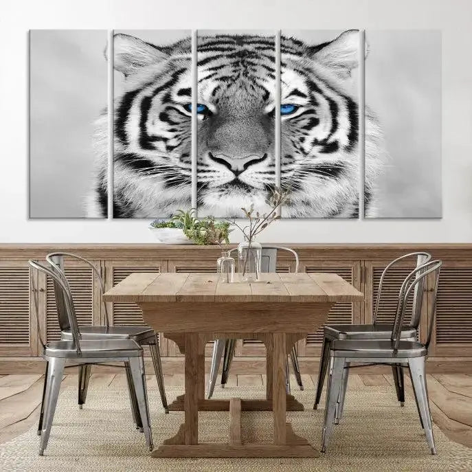 A piece from the Black and White Tiger Wall Art Animal Canvas Print collection, showcasing a white tiger with blue eyes on premium canvas, is displayed.