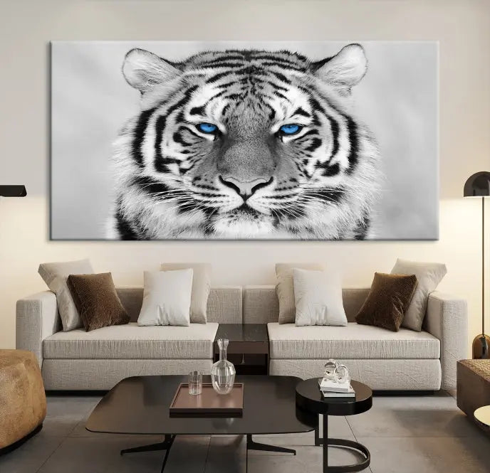 A piece from the Black and White Tiger Wall Art Animal Canvas Print collection, showcasing a white tiger with blue eyes on premium canvas, is displayed.