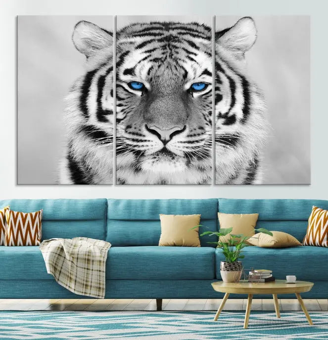 A piece from the Black and White Tiger Wall Art Animal Canvas Print collection, showcasing a white tiger with blue eyes on premium canvas, is displayed.