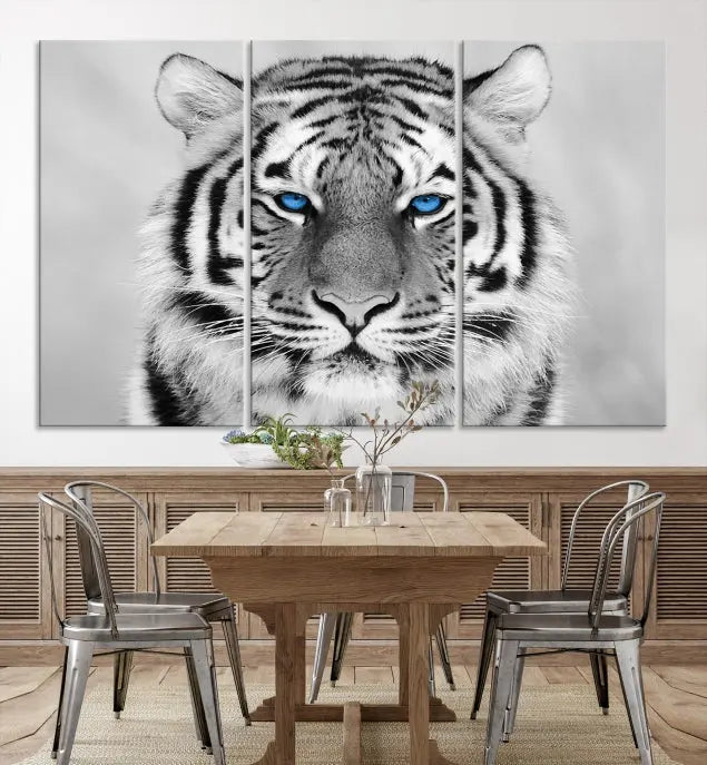 A piece from the Black and White Tiger Wall Art Animal Canvas Print collection, showcasing a white tiger with blue eyes on premium canvas, is displayed.