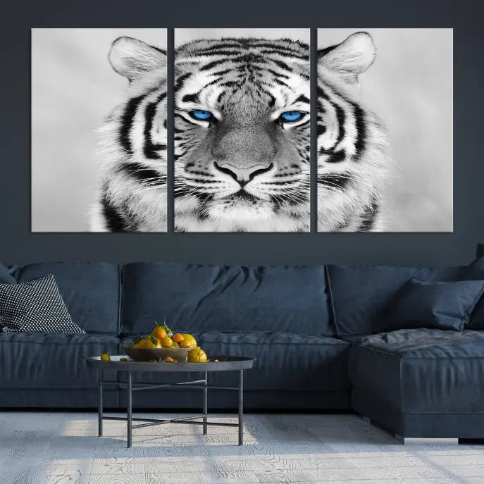 A piece from the Black and White Tiger Wall Art Animal Canvas Print collection, showcasing a white tiger with blue eyes on premium canvas, is displayed.