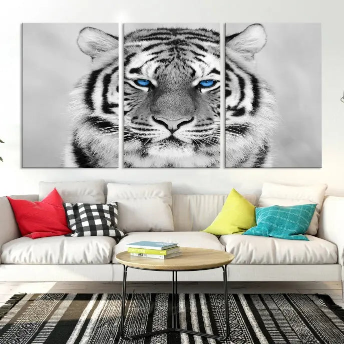 A piece from the Black and White Tiger Wall Art Animal Canvas Print collection, showcasing a white tiger with blue eyes on premium canvas, is displayed.