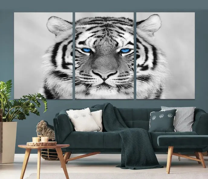 A piece from the Black and White Tiger Wall Art Animal Canvas Print collection, showcasing a white tiger with blue eyes on premium canvas, is displayed.