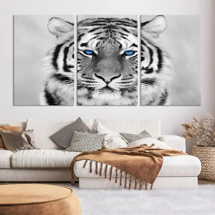 A piece from the Black and White Tiger Wall Art Animal Canvas Print collection, showcasing a white tiger with blue eyes on premium canvas, is displayed.