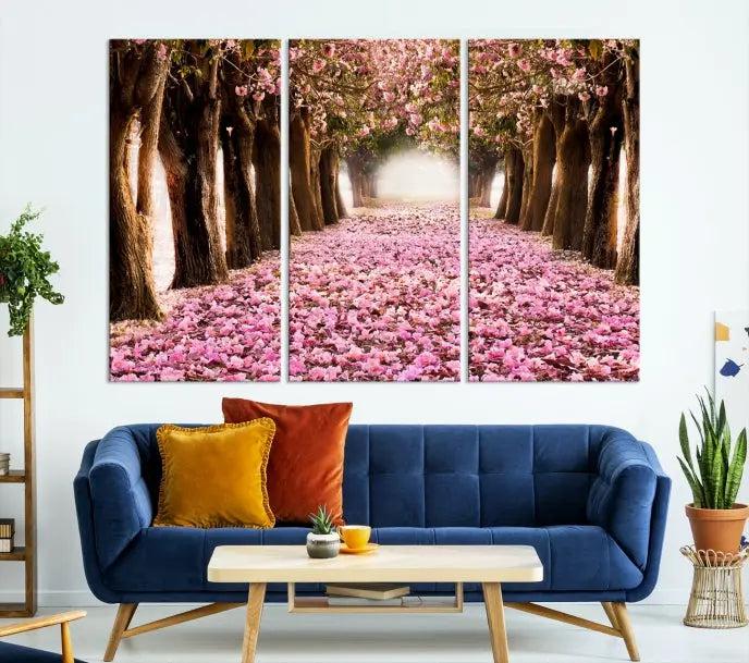 The Blossom Cherry Trees Wall Art Canvas Print, featuring a three-panel design on museum-quality canvas, showcases a tree-lined path with pink flowers. Each panel is gallery wrapped to add an extra layer of sophistication.