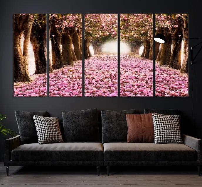 The Blossom Cherry Trees Wall Art Canvas Print, featuring a three-panel design on museum-quality canvas, showcases a tree-lined path with pink flowers. Each panel is gallery wrapped to add an extra layer of sophistication.