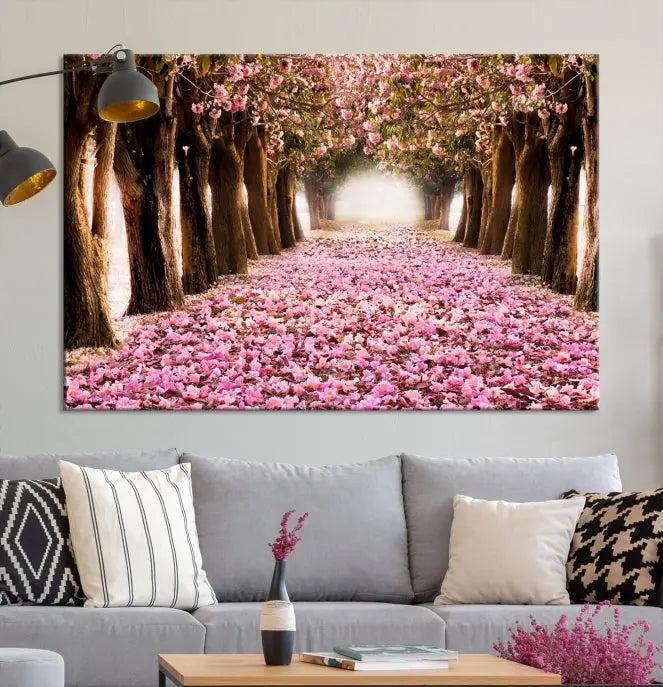 The Blossom Cherry Trees Wall Art Canvas Print, featuring a three-panel design on museum-quality canvas, showcases a tree-lined path with pink flowers. Each panel is gallery wrapped to add an extra layer of sophistication.