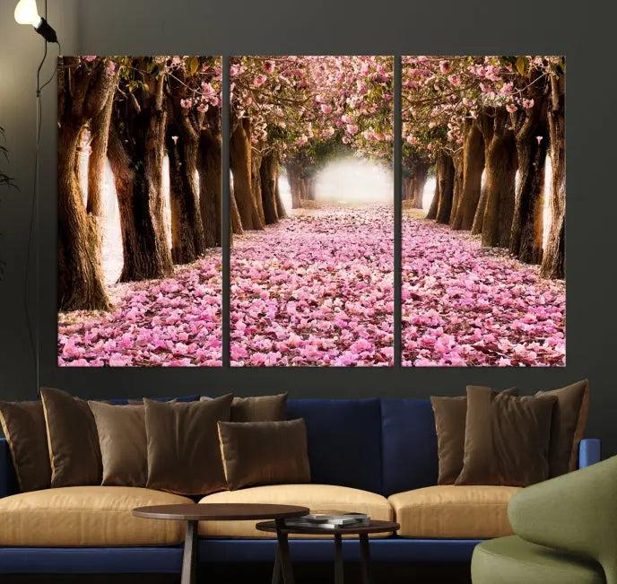 The Blossom Cherry Trees Wall Art Canvas Print, featuring a three-panel design on museum-quality canvas, showcases a tree-lined path with pink flowers. Each panel is gallery wrapped to add an extra layer of sophistication.