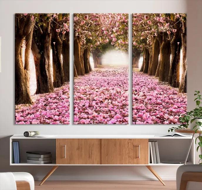 The Blossom Cherry Trees Wall Art Canvas Print, featuring a three-panel design on museum-quality canvas, showcases a tree-lined path with pink flowers. Each panel is gallery wrapped to add an extra layer of sophistication.