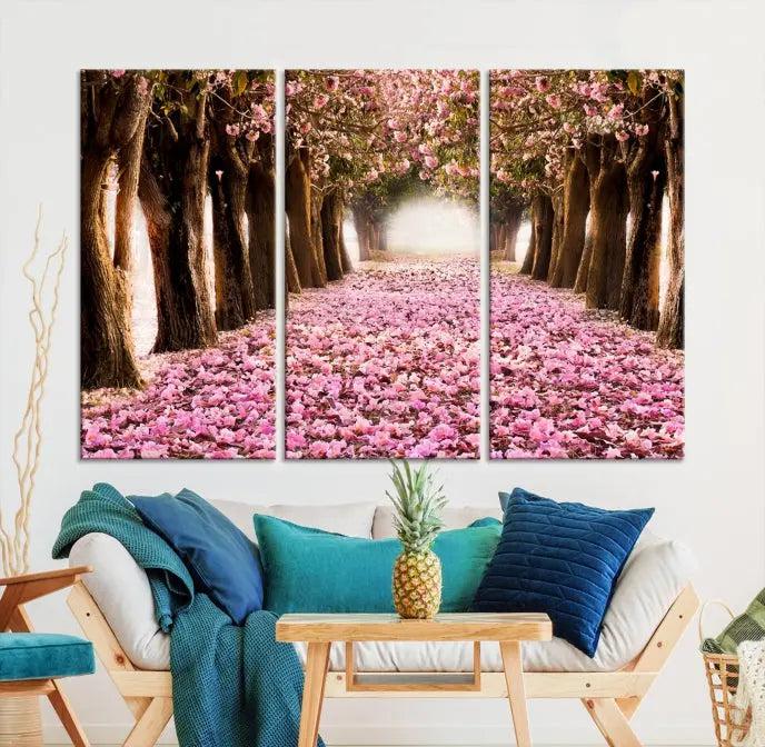 The Blossom Cherry Trees Wall Art Canvas Print, featuring a three-panel design on museum-quality canvas, showcases a tree-lined path with pink flowers. Each panel is gallery wrapped to add an extra layer of sophistication.