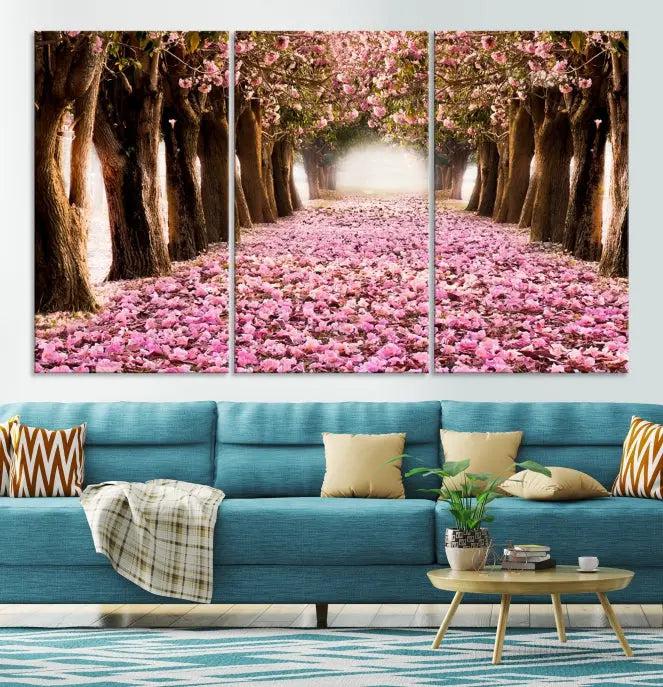 The Blossom Cherry Trees Wall Art Canvas Print, featuring a three-panel design on museum-quality canvas, showcases a tree-lined path with pink flowers. Each panel is gallery wrapped to add an extra layer of sophistication.