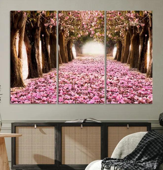 The Blossom Cherry Trees Wall Art Canvas Print, featuring a three-panel design on museum-quality canvas, showcases a tree-lined path with pink flowers. Each panel is gallery wrapped to add an extra layer of sophistication.