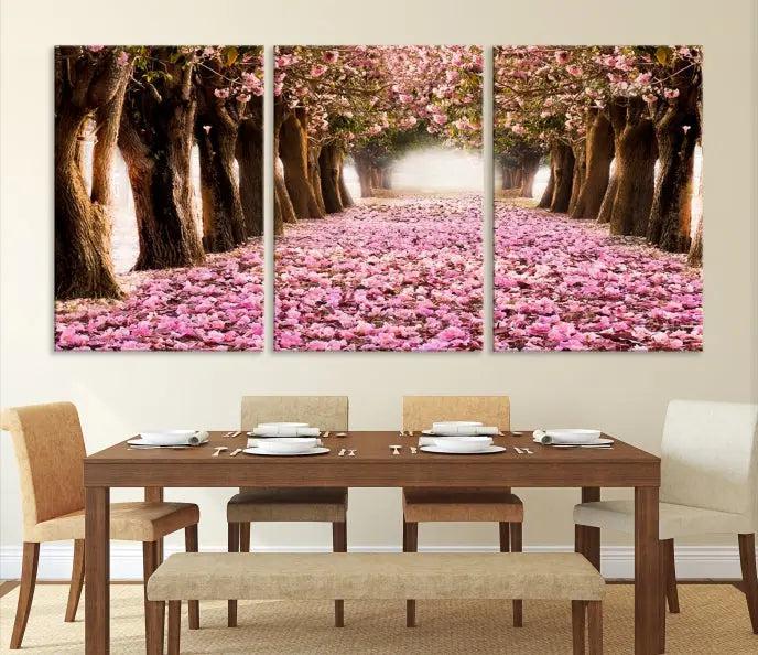 The Blossom Cherry Trees Wall Art Canvas Print, featuring a three-panel design on museum-quality canvas, showcases a tree-lined path with pink flowers. Each panel is gallery wrapped to add an extra layer of sophistication.