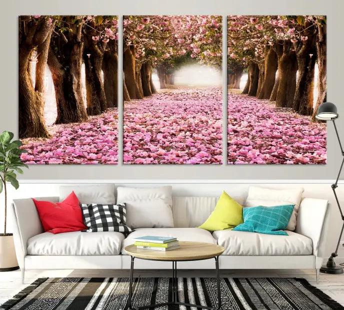 The Blossom Cherry Trees Wall Art Canvas Print, featuring a three-panel design on museum-quality canvas, showcases a tree-lined path with pink flowers. Each panel is gallery wrapped to add an extra layer of sophistication.