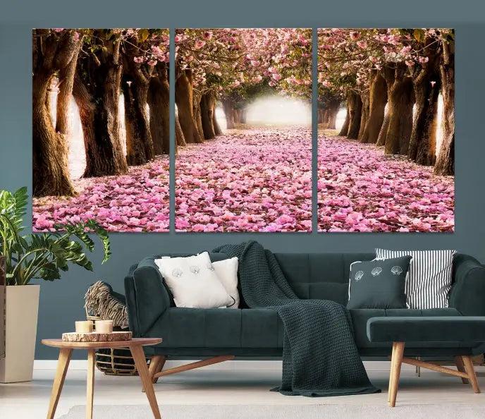 The Blossom Cherry Trees Wall Art Canvas Print, featuring a three-panel design on museum-quality canvas, showcases a tree-lined path with pink flowers. Each panel is gallery wrapped to add an extra layer of sophistication.