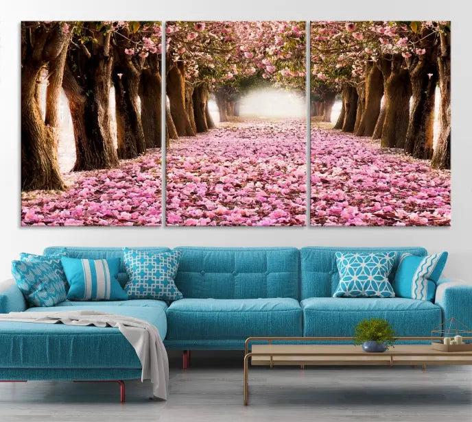 The Blossom Cherry Trees Wall Art Canvas Print, featuring a three-panel design on museum-quality canvas, showcases a tree-lined path with pink flowers. Each panel is gallery wrapped to add an extra layer of sophistication.