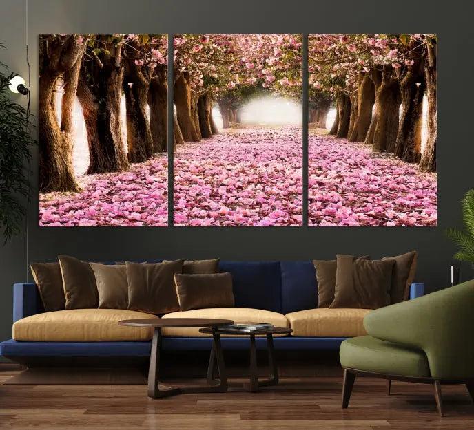 The Blossom Cherry Trees Wall Art Canvas Print, featuring a three-panel design on museum-quality canvas, showcases a tree-lined path with pink flowers. Each panel is gallery wrapped to add an extra layer of sophistication.