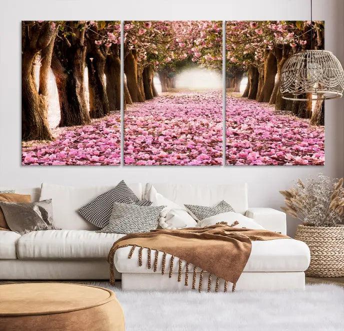 The Blossom Cherry Trees Wall Art Canvas Print, featuring a three-panel design on museum-quality canvas, showcases a tree-lined path with pink flowers. Each panel is gallery wrapped to add an extra layer of sophistication.