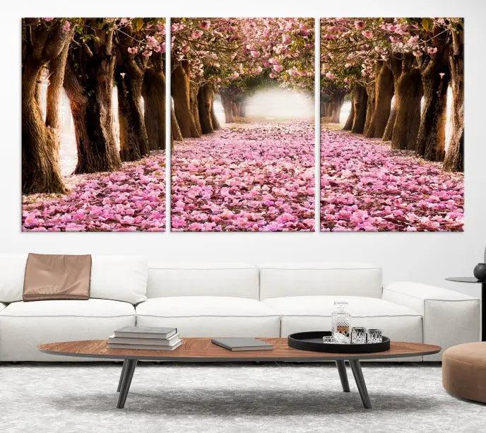 The Blossom Cherry Trees Wall Art Canvas Print, featuring a three-panel design on museum-quality canvas, showcases a tree-lined path with pink flowers. Each panel is gallery wrapped to add an extra layer of sophistication.