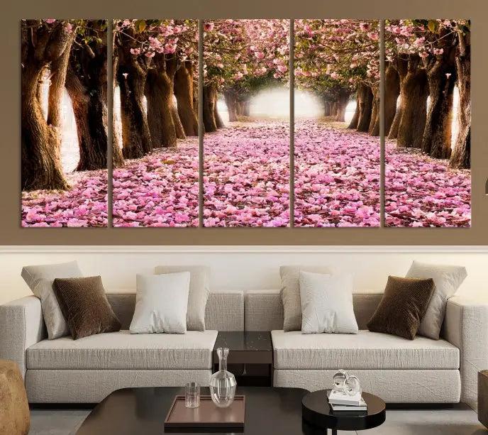 The Blossom Cherry Trees Wall Art Canvas Print, featuring a three-panel design on museum-quality canvas, showcases a tree-lined path with pink flowers. Each panel is gallery wrapped to add an extra layer of sophistication.