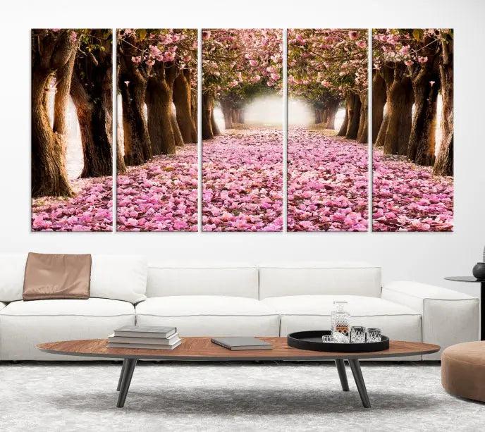 The Blossom Cherry Trees Wall Art Canvas Print, featuring a three-panel design on museum-quality canvas, showcases a tree-lined path with pink flowers. Each panel is gallery wrapped to add an extra layer of sophistication.