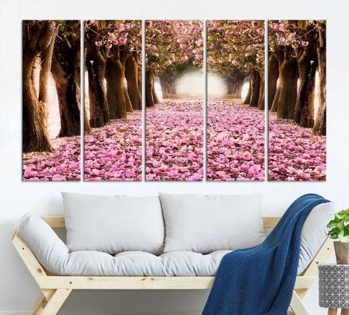 The Blossom Cherry Trees Wall Art Canvas Print, featuring a three-panel design on museum-quality canvas, showcases a tree-lined path with pink flowers. Each panel is gallery wrapped to add an extra layer of sophistication.