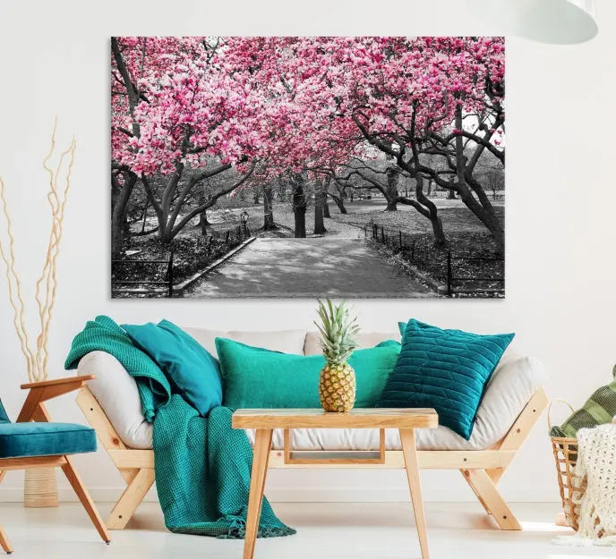 The "Blossom Cherry Trees and Leaves Wall Art Canvas Print" is a gallery-wrapped canvas that features a stunning depiction of a park path lined with pink blossoming trees in sepia tones. Its timeless beauty is preserved with a UV-protective coating.