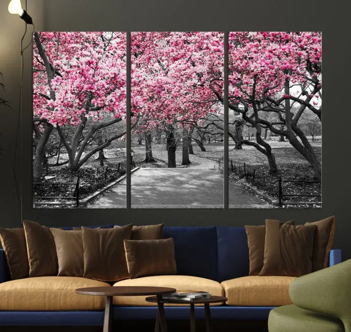 The "Blossom Cherry Trees and Leaves Wall Art Canvas Print" is a gallery-wrapped canvas that features a stunning depiction of a park path lined with pink blossoming trees in sepia tones. Its timeless beauty is preserved with a UV-protective coating.