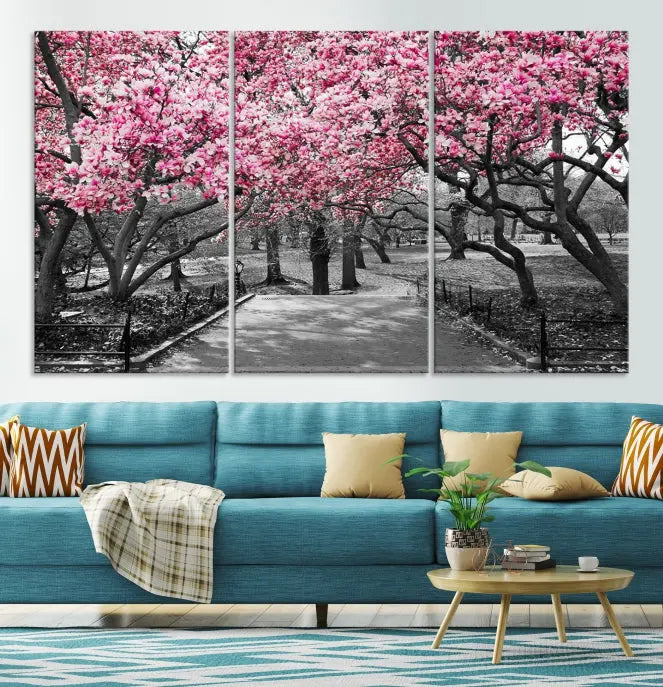 The "Blossom Cherry Trees and Leaves Wall Art Canvas Print" is a gallery-wrapped canvas that features a stunning depiction of a park path lined with pink blossoming trees in sepia tones. Its timeless beauty is preserved with a UV-protective coating.