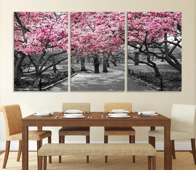 The "Blossom Cherry Trees and Leaves Wall Art Canvas Print" is a gallery-wrapped canvas that features a stunning depiction of a park path lined with pink blossoming trees in sepia tones. Its timeless beauty is preserved with a UV-protective coating.