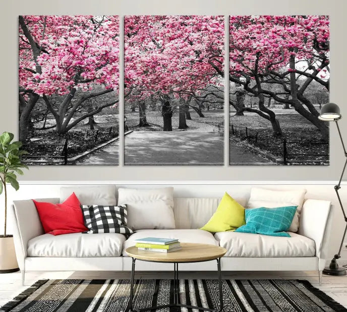 The "Blossom Cherry Trees and Leaves Wall Art Canvas Print" is a gallery-wrapped canvas that features a stunning depiction of a park path lined with pink blossoming trees in sepia tones. Its timeless beauty is preserved with a UV-protective coating.