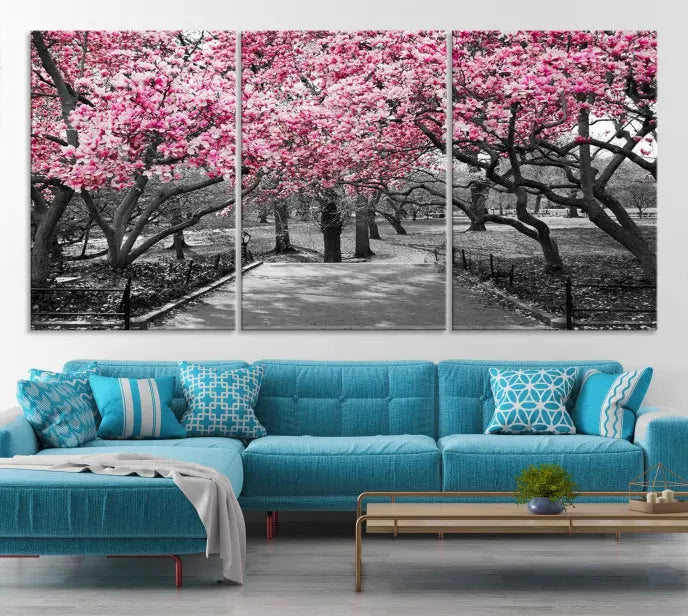 The "Blossom Cherry Trees and Leaves Wall Art Canvas Print" is a gallery-wrapped canvas that features a stunning depiction of a park path lined with pink blossoming trees in sepia tones. Its timeless beauty is preserved with a UV-protective coating.