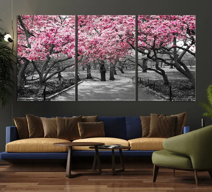 The "Blossom Cherry Trees and Leaves Wall Art Canvas Print" is a gallery-wrapped canvas that features a stunning depiction of a park path lined with pink blossoming trees in sepia tones. Its timeless beauty is preserved with a UV-protective coating.