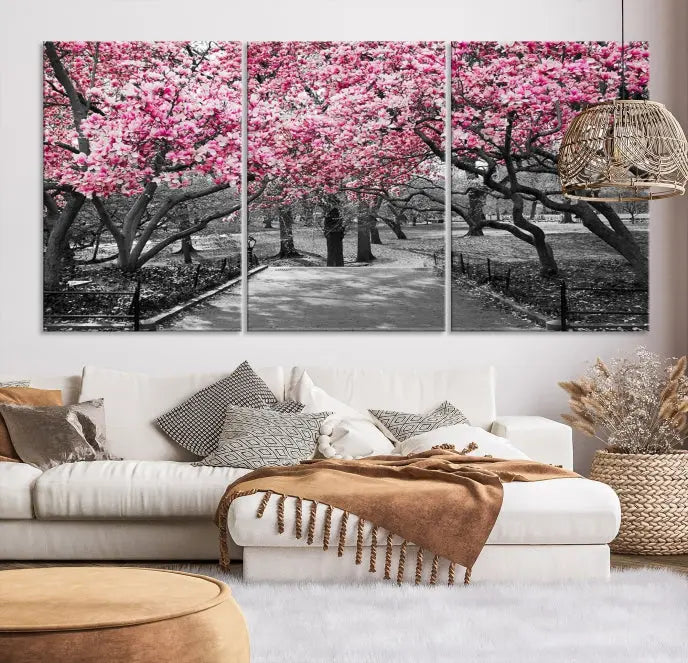 The "Blossom Cherry Trees and Leaves Wall Art Canvas Print" is a gallery-wrapped canvas that features a stunning depiction of a park path lined with pink blossoming trees in sepia tones. Its timeless beauty is preserved with a UV-protective coating.