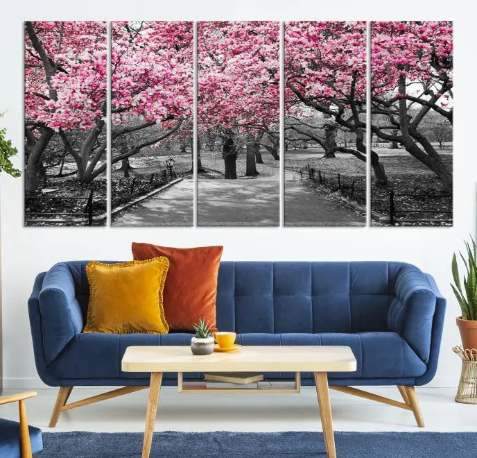 The "Blossom Cherry Trees and Leaves Wall Art Canvas Print" is a gallery-wrapped canvas that features a stunning depiction of a park path lined with pink blossoming trees in sepia tones. Its timeless beauty is preserved with a UV-protective coating.