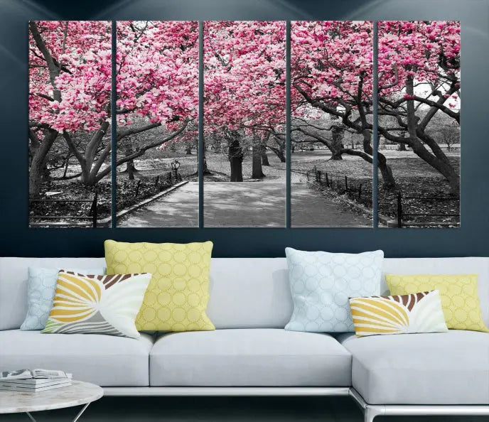 The "Blossom Cherry Trees and Leaves Wall Art Canvas Print" is a gallery-wrapped canvas that features a stunning depiction of a park path lined with pink blossoming trees in sepia tones. Its timeless beauty is preserved with a UV-protective coating.