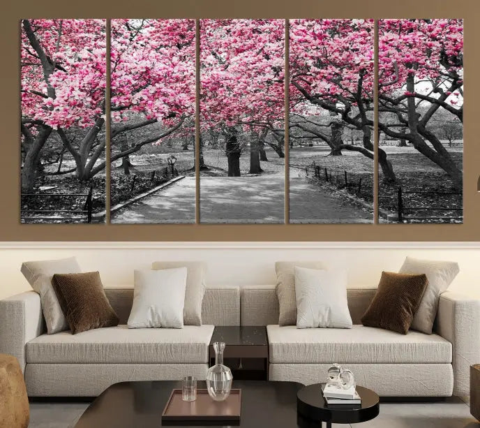 The "Blossom Cherry Trees and Leaves Wall Art Canvas Print" is a gallery-wrapped canvas that features a stunning depiction of a park path lined with pink blossoming trees in sepia tones. Its timeless beauty is preserved with a UV-protective coating.