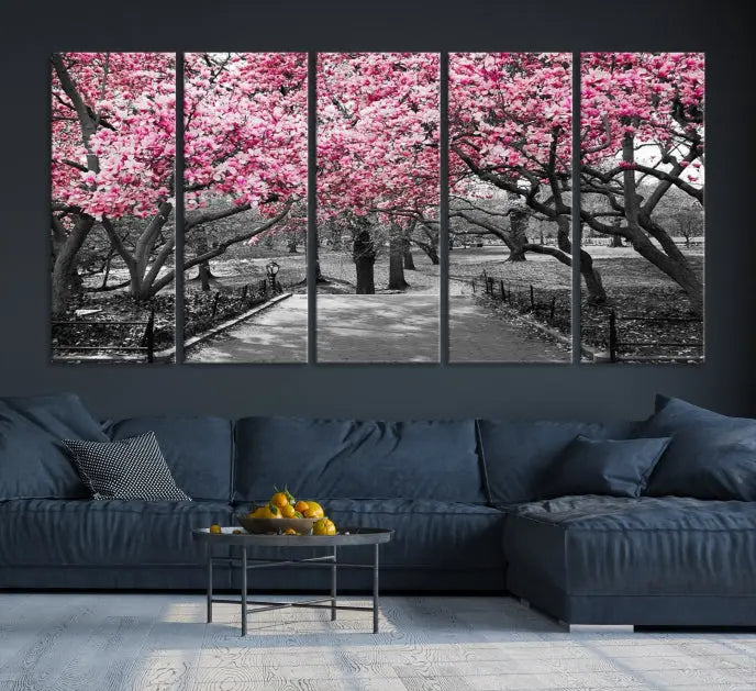 The "Blossom Cherry Trees and Leaves Wall Art Canvas Print" is a gallery-wrapped canvas that features a stunning depiction of a park path lined with pink blossoming trees in sepia tones. Its timeless beauty is preserved with a UV-protective coating.