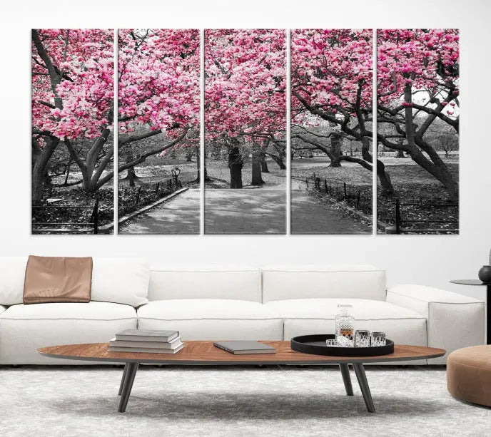 The "Blossom Cherry Trees and Leaves Wall Art Canvas Print" is a gallery-wrapped canvas that features a stunning depiction of a park path lined with pink blossoming trees in sepia tones. Its timeless beauty is preserved with a UV-protective coating.