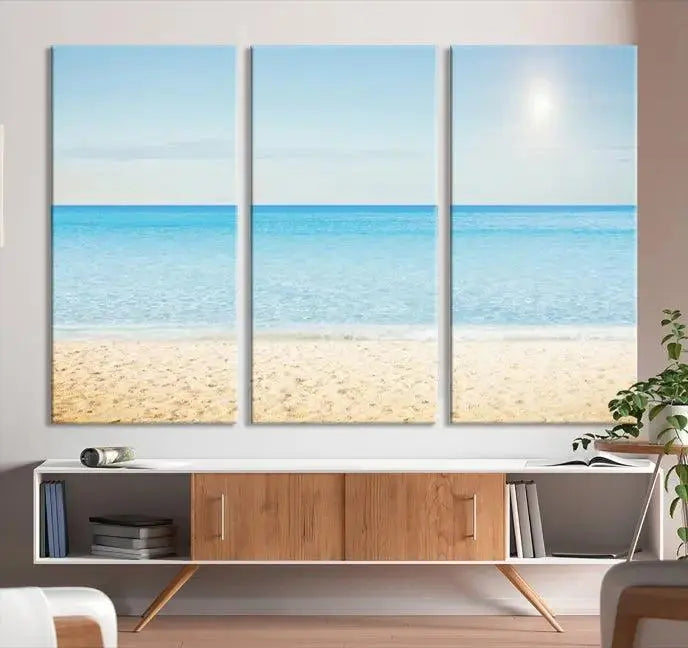 The Blue Beach and Sea Wall Art Canvas Print, arranged in a three-panel beach scene, elegantly decorates a black wall. Transform your space into a coastal oasis with this stunning piece, and enjoy free shipping on your purchase.