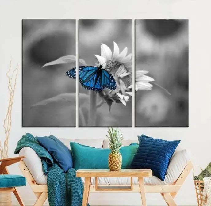 The modern living room showcases the Blue Butterfly Black and White Canvas Wall Art as a triptych. These museum-quality canvases, equipped with UV-protective coating and ready to hang, add both elegance and durability to the decor.