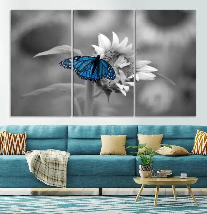 The modern living room showcases the Blue Butterfly Black and White Canvas Wall Art as a triptych. These museum-quality canvases, equipped with UV-protective coating and ready to hang, add both elegance and durability to the decor.