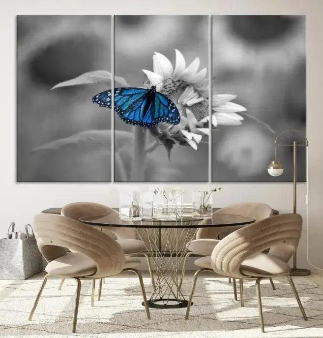 The modern living room showcases the Blue Butterfly Black and White Canvas Wall Art as a triptych. These museum-quality canvases, equipped with UV-protective coating and ready to hang, add both elegance and durability to the decor.