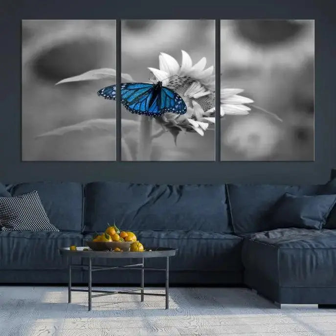 The modern living room showcases the Blue Butterfly Black and White Canvas Wall Art as a triptych. These museum-quality canvases, equipped with UV-protective coating and ready to hang, add both elegance and durability to the decor.