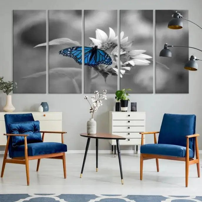 The modern living room showcases the Blue Butterfly Black and White Canvas Wall Art as a triptych. These museum-quality canvases, equipped with UV-protective coating and ready to hang, add both elegance and durability to the decor.