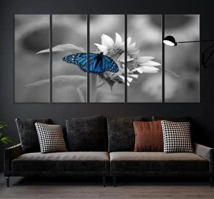 The modern living room showcases the Blue Butterfly Black and White Canvas Wall Art as a triptych. These museum-quality canvases, equipped with UV-protective coating and ready to hang, add both elegance and durability to the decor.