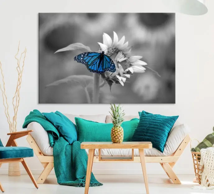 The modern living room showcases the Blue Butterfly Black and White Canvas Wall Art as a triptych. These museum-quality canvases, equipped with UV-protective coating and ready to hang, add both elegance and durability to the decor.